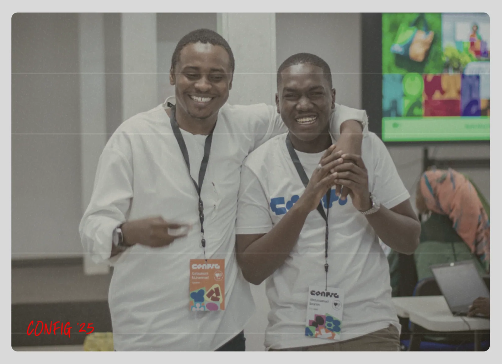 Two organisers laughing together at the Config watch party in Kano