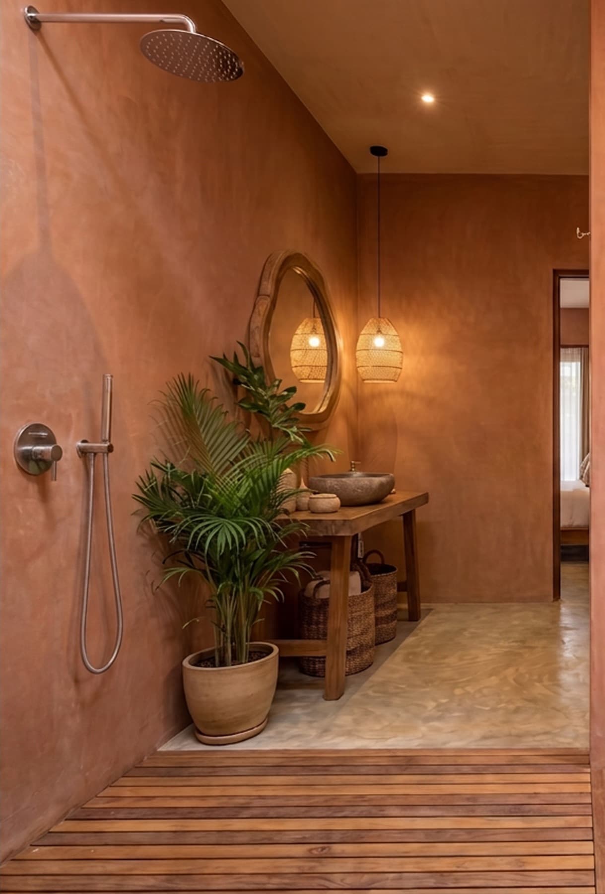 Bathroom with rain shower, teak slat floor, round mirror and stone basin